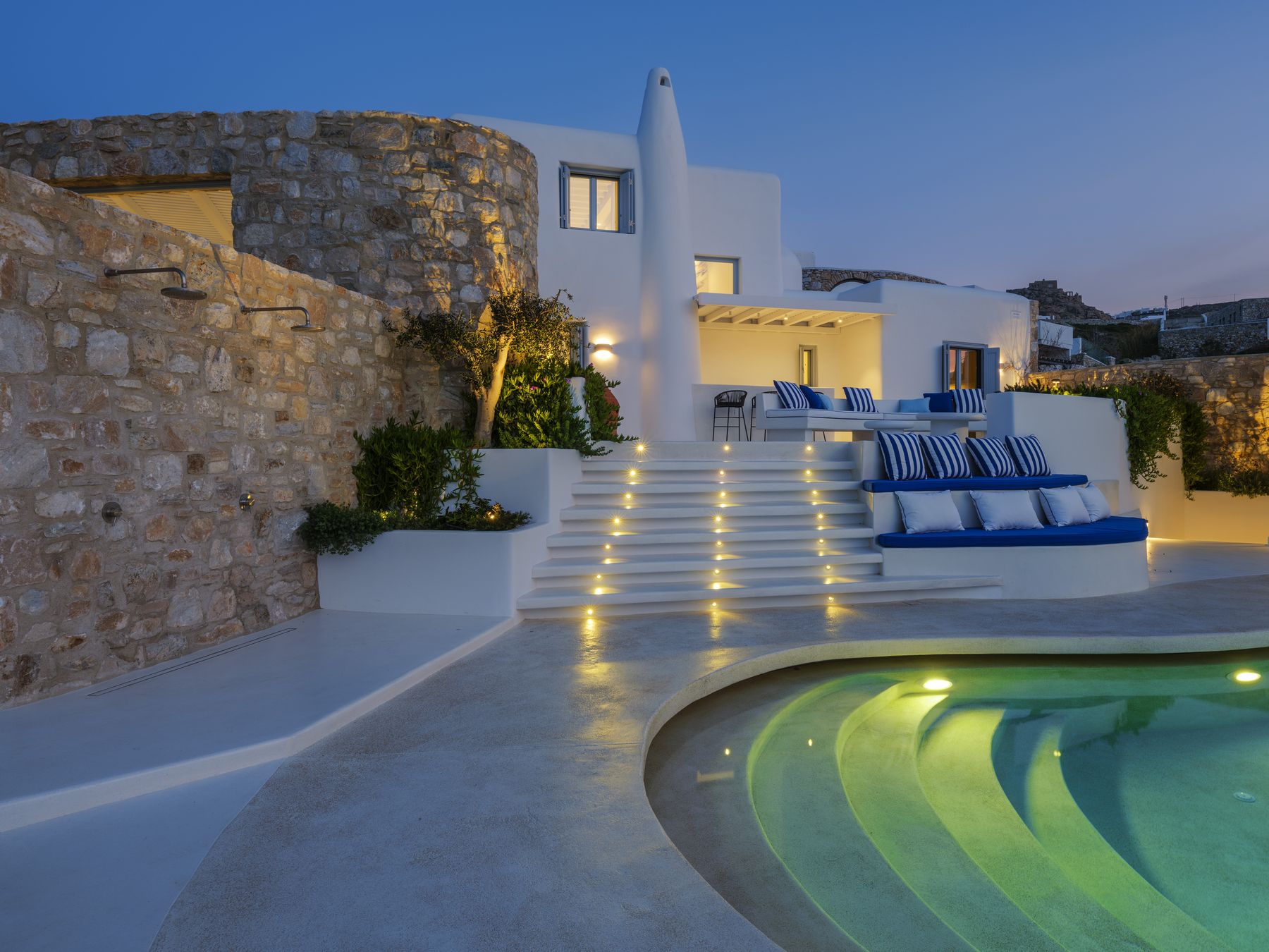 The pool, steps and stone tower at dusk