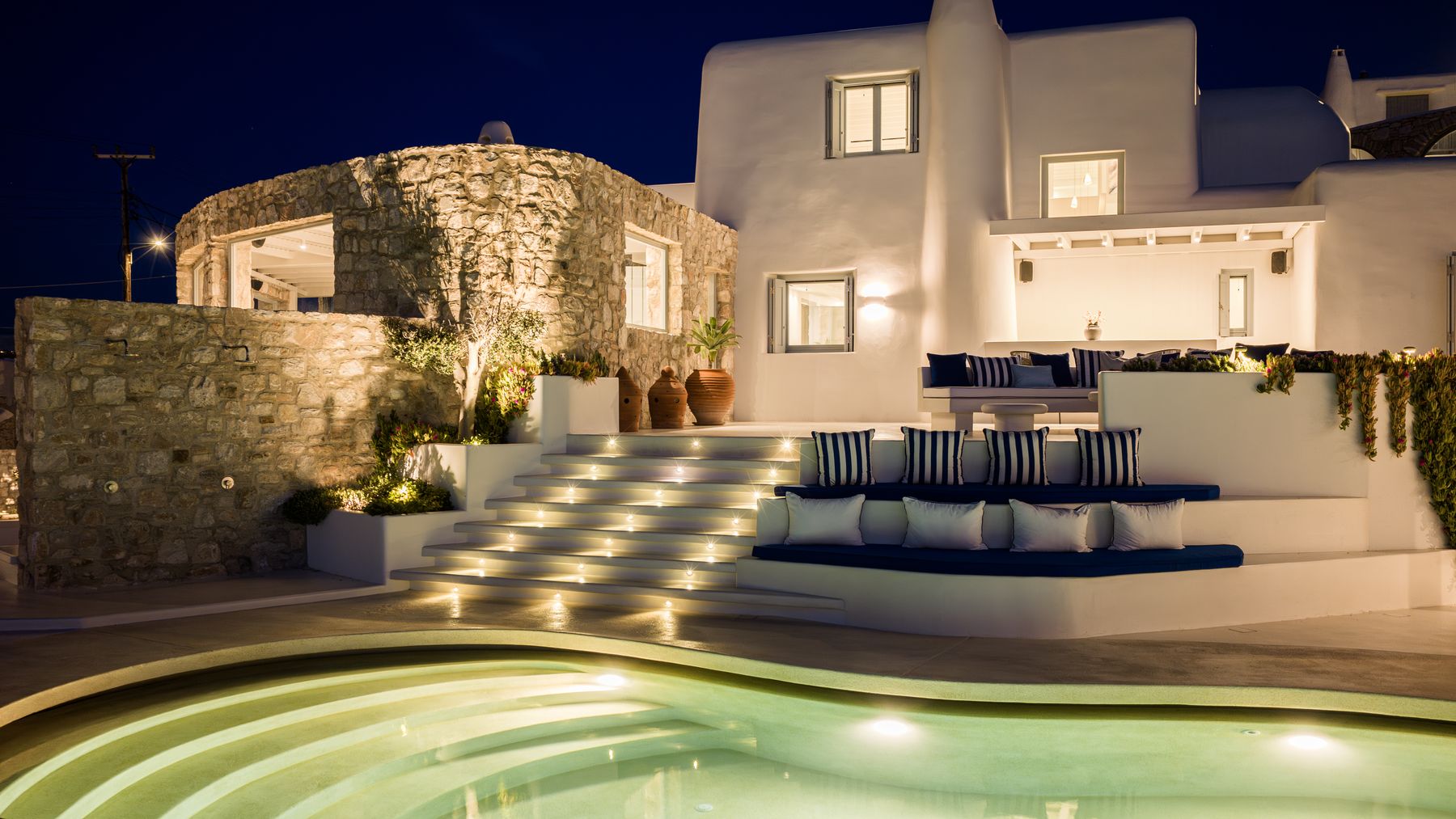 The villa and pool lit up at night