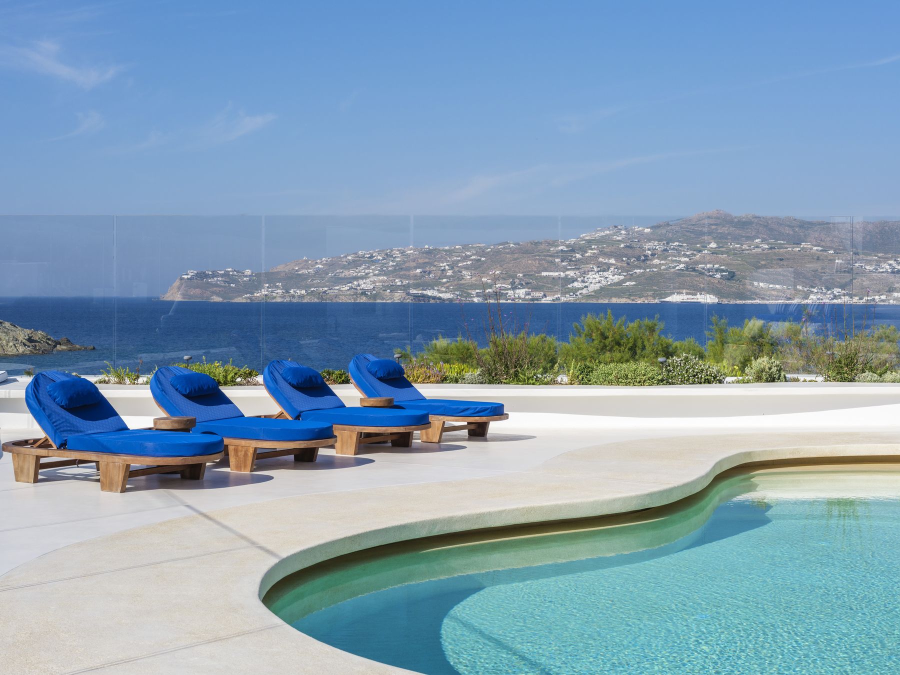 Sun loungers above the pool with sea view